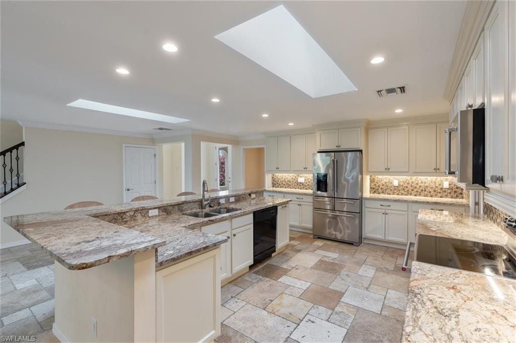 4851 Riverside Drive Estero, FL 33928 - Photo 5 of 35 a kitchen with a sink and stove top oven