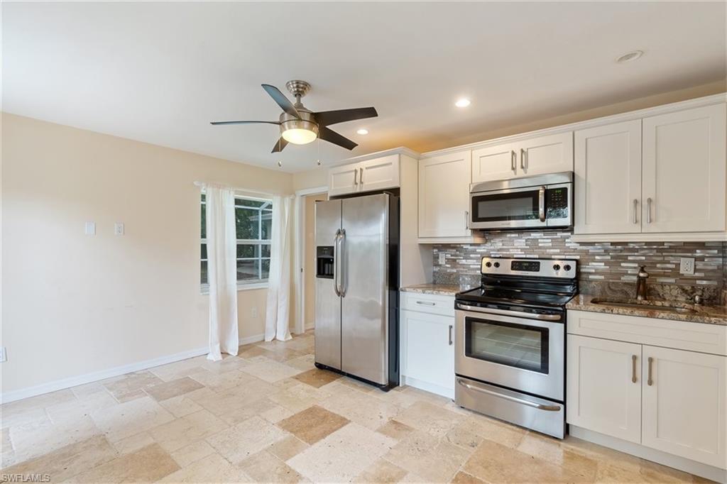 4851 Riverside Drive Estero, FL 33928 - Photo 8 of 35 a kitchen with stainless steel appliances a stove microwave and refrigerator