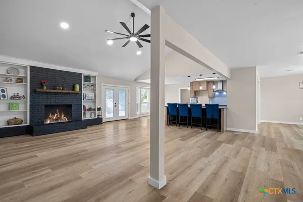 a view of a livingroom with a fireplace and cabinet
