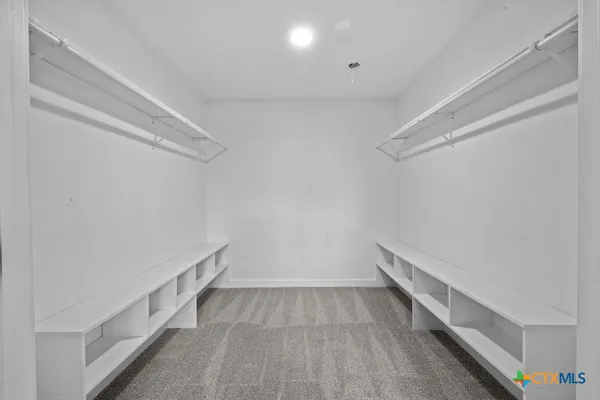 a view of hallway with stairs and wooden floor