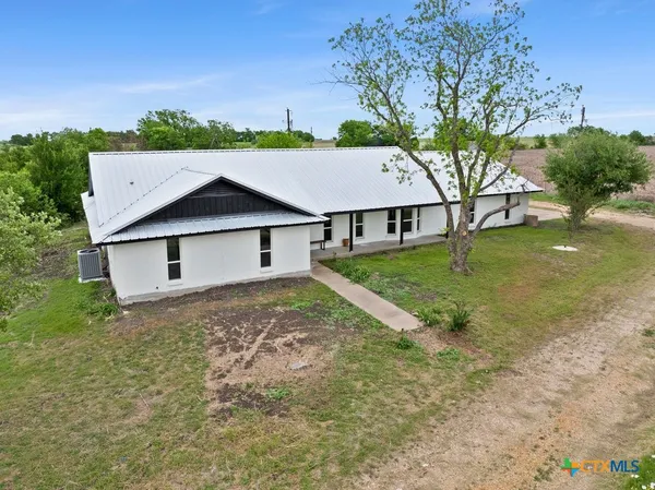 a house that has tree in front of the house