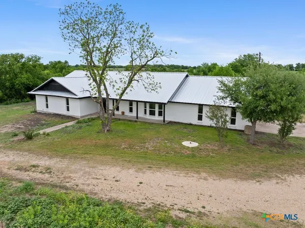 a view of a house with a yard garage and sitting area