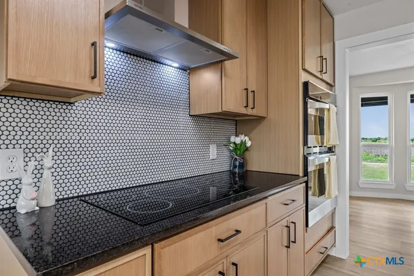 a kitchen with granite countertop cabinets and a stove