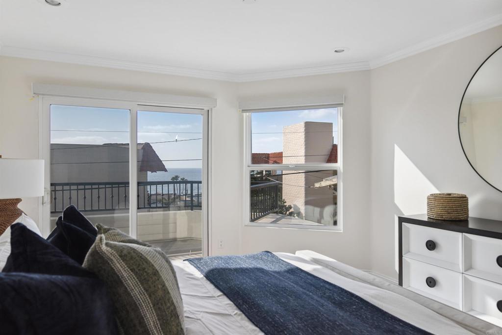 848 Prospect Street, Unit C La Jolla, CA 92037 - Photo 15 of 24 a living room with a bed furniture and a window