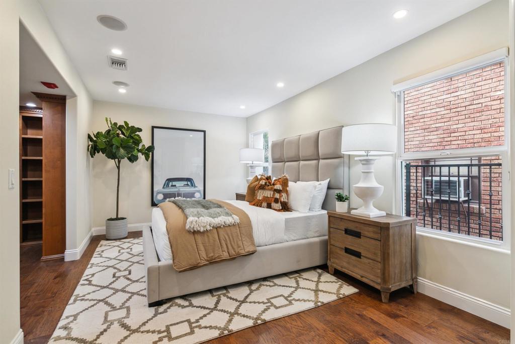 848 Prospect Street, Unit C La Jolla, CA 92037 - Photo 18 of 24 a bedroom with bed and window