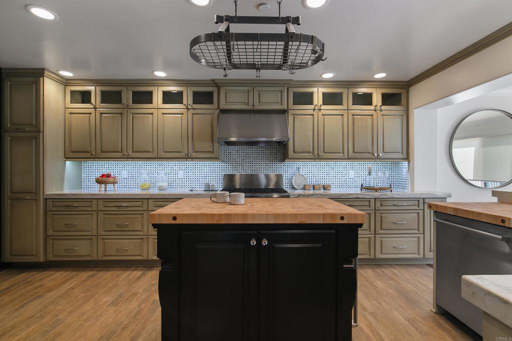 848 Prospect Street, Unit C La Jolla, CA 92037 - Photo 7 of 24 a kitchen with granite countertop a sink stove and cabinets