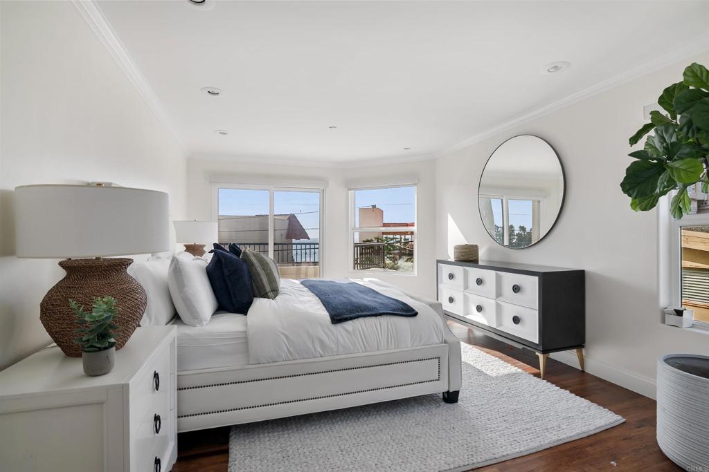 848 Prospect Street, Unit C La Jolla, CA 92037 - Photo 8 of 24 a bedroom with a bed a mirror and a table in it
