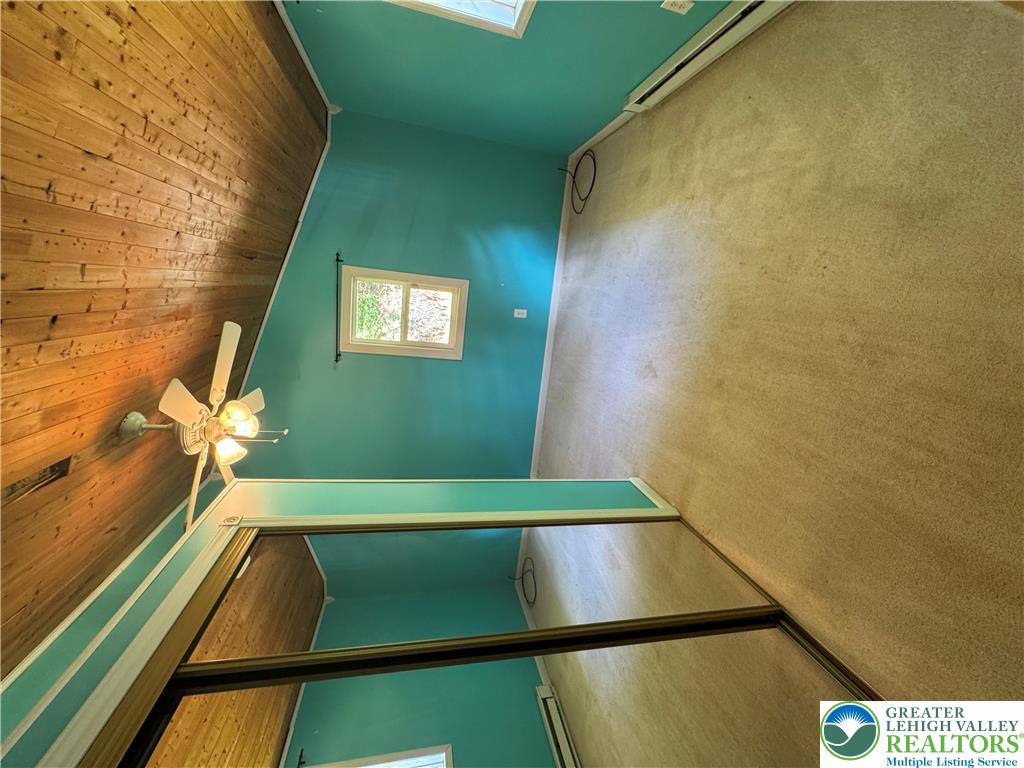 134 Bear Road Kunkletown, PA 18058 - Photo 37 of 42 Rich wood plank ceilings rise above soft carpeting and mirrored sliding closet doors.