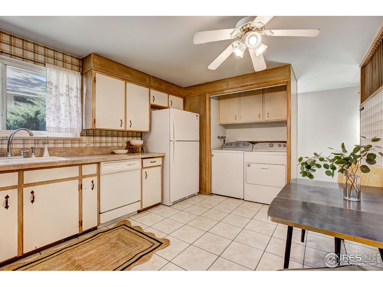 620 West Myrtle Street Fort Collins, CO 80521 - Photo 13 of 30 a kitchen with a refrigerator a stove a dining table and chairs