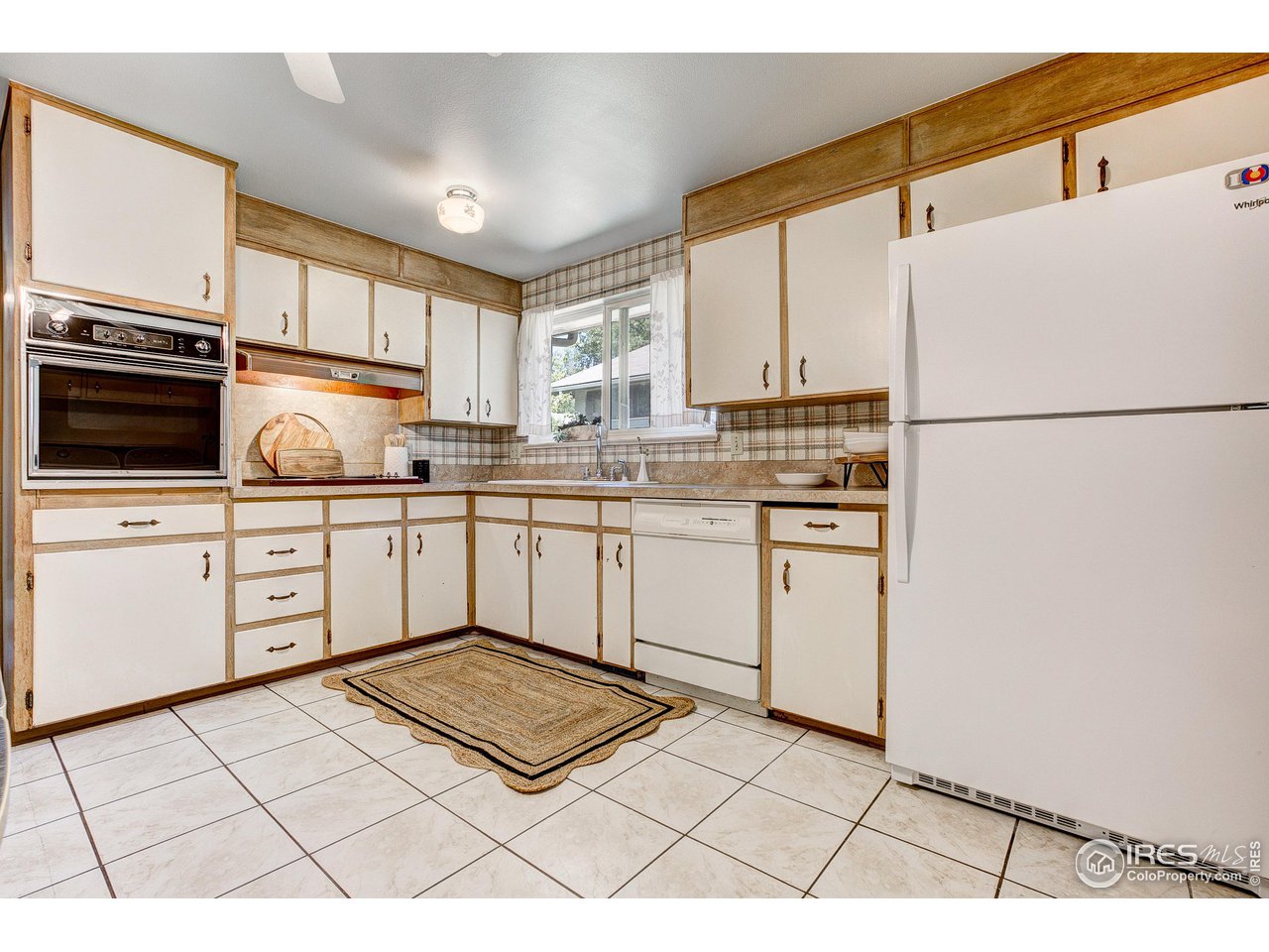 620 West Myrtle Street Fort Collins, CO 80521 - Photo 15 of 30 a kitchen with white cabinets a sink appliances and a window