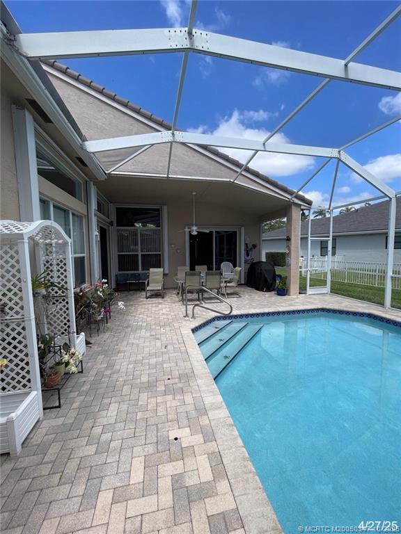 4513 Southwest 185th Avenue Miramar, FL 33029 - Photo 12 of 66 a view of a patio with table and chairs under an umbrella