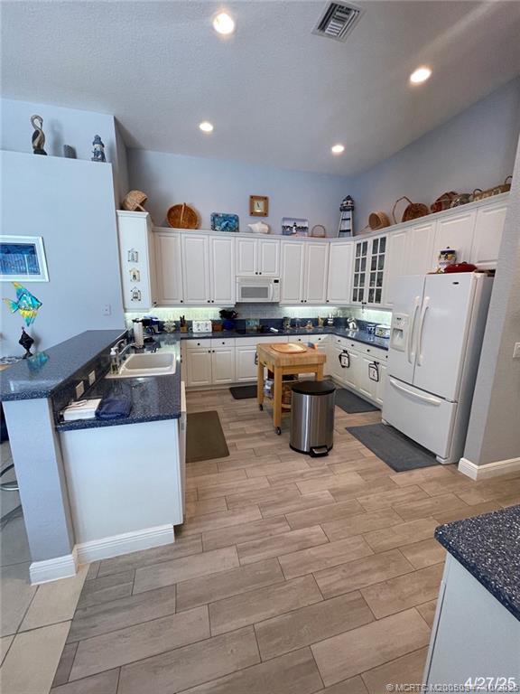 4513 Southwest 185th Avenue Miramar, FL 33029 - Photo 21 of 66 a kitchen with wooden cabinets and white appliances