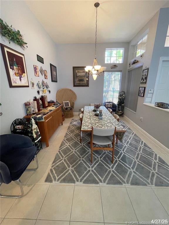 4513 Southwest 185th Avenue Miramar, FL 33029 - Photo 22 of 66 a living room with furniture a chandelier and a table
