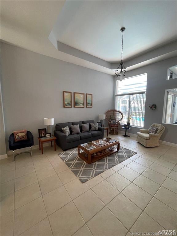 4513 Southwest 185th Avenue Miramar, FL 33029 - Photo 24 of 66 a living room with furniture and a chandelier