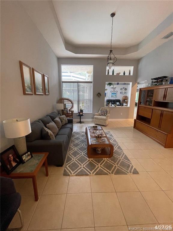 4513 Southwest 185th Avenue Miramar, FL 33029 - Photo 52 of 66 a living room with furniture a chandelier and a window