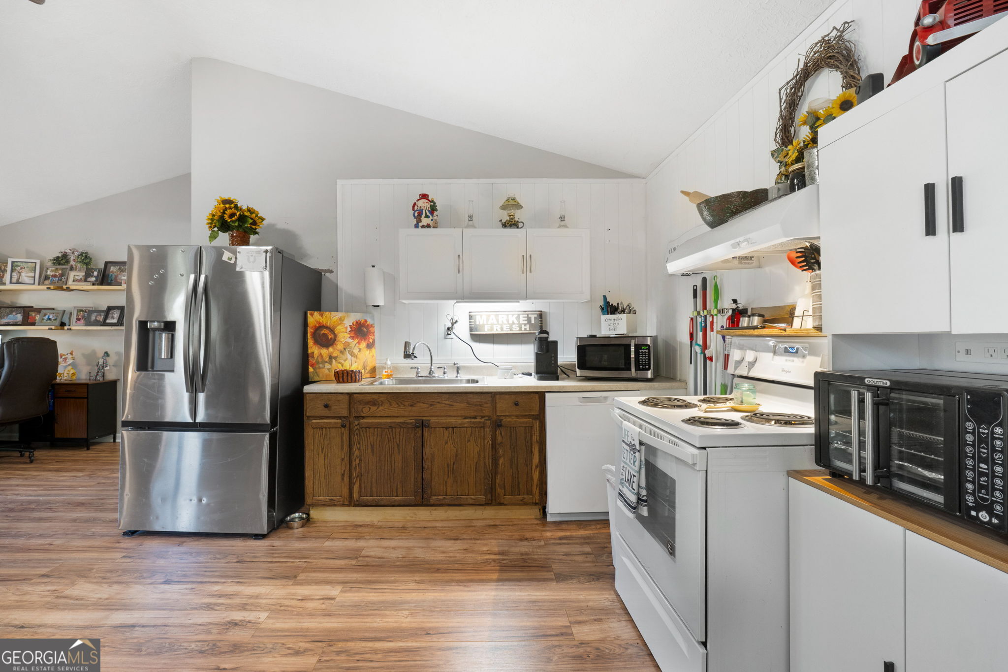196 Horseshoe Bend Road Jackson, GA 30233 - Photo 10 of 21 a kitchen with a refrigerator and a stove top oven