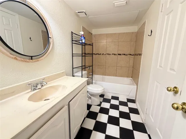 a bathroom with a sink a toilet and a mirror