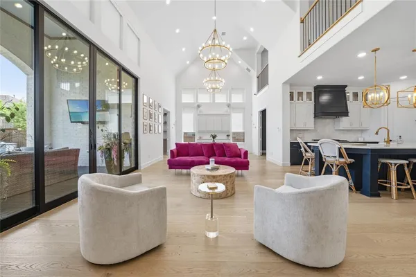 a view of kitchen with stainless steel appliances kitchen island dining table and chairs