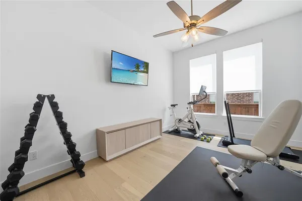 a living room with furniture gym equipment and a large window