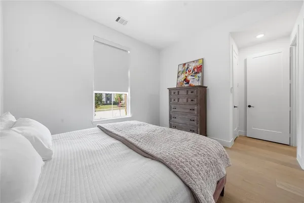 a bedroom with a bed and a window