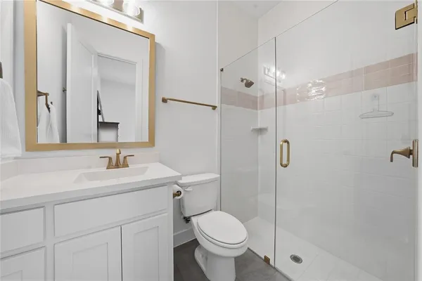 a bathroom with a sink toilet and shower