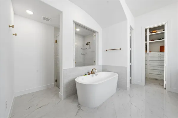 a white bath tub sitting in a bathroom