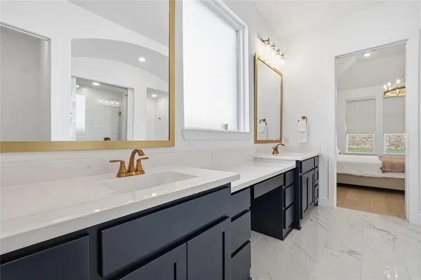a bathroom with a sink double vanity and a mirror