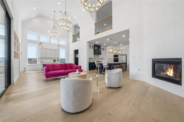 a living room with furniture and a chandelier