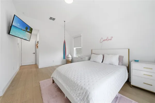 a bedroom with a bed and a night stand