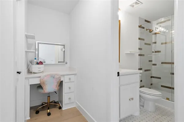 a bathroom with a sink toilet a mirror and shower