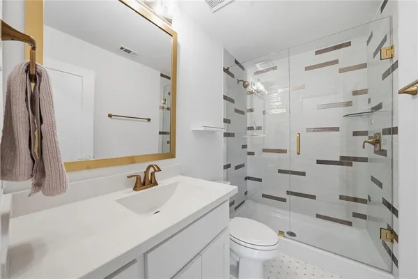 a bathroom with a sink toilet and shower