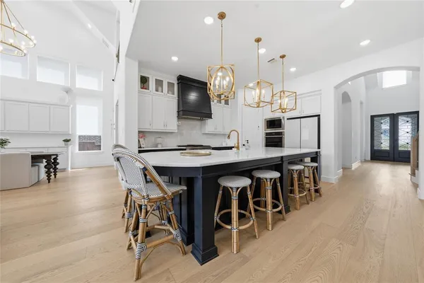a large kitchen with a table and chairs