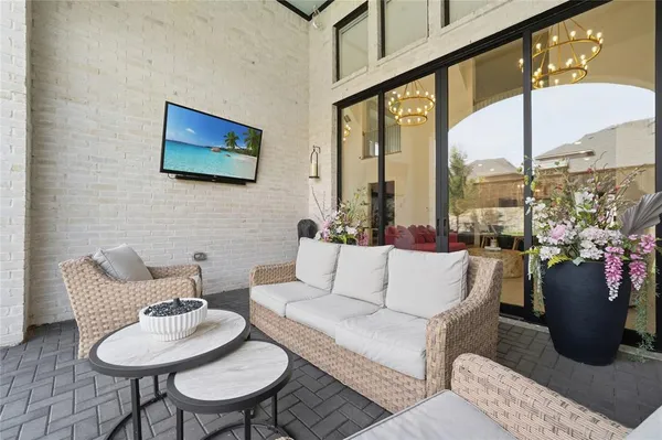 a living room with furniture and a floor to ceiling window