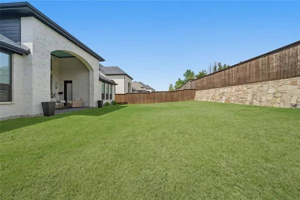 a big house with a big yard and large trees