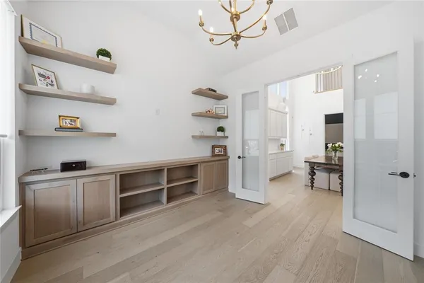 a view of a kitchen with wooden floor and cabinets