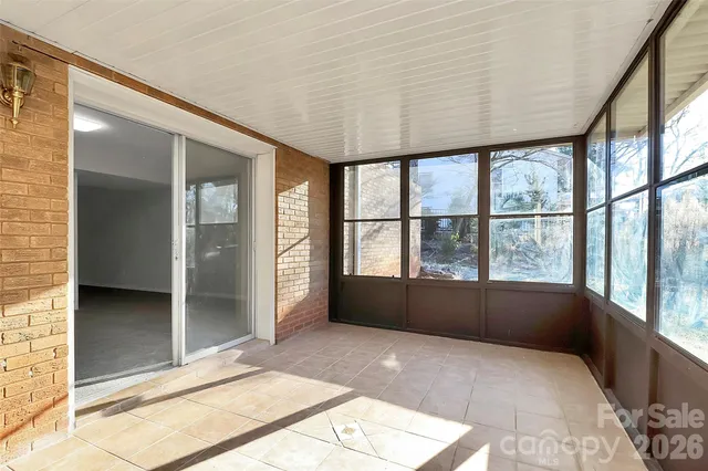 an empty room with large windows