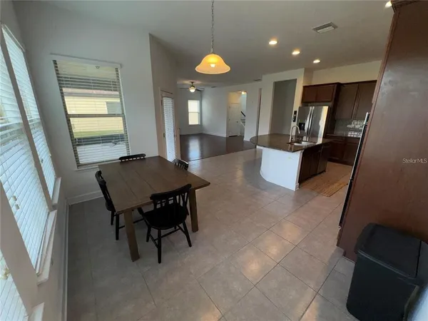 a view of kitchen with dining table and chairs