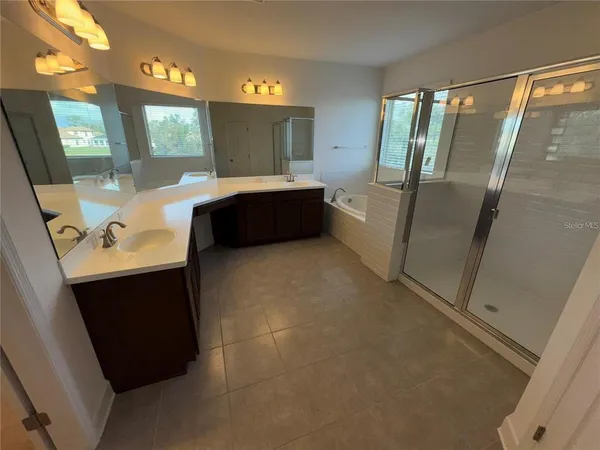 a bathroom with a double vanity sink and mirror