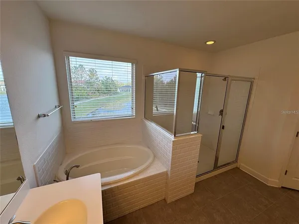 a bathroom with a tub and shower