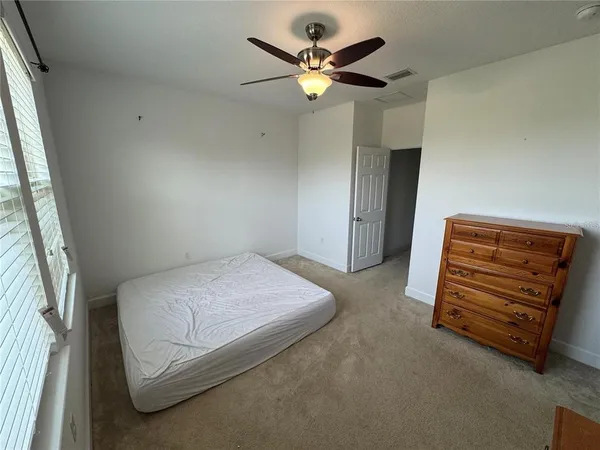 a bedroom with a bed and a large mirror