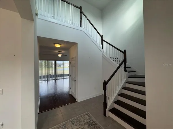 a view of entryway and hall with wooden floor