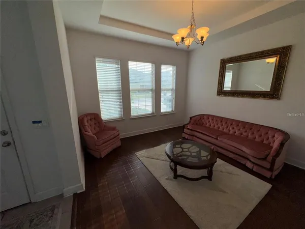 a living room with furniture flowerpot and a window