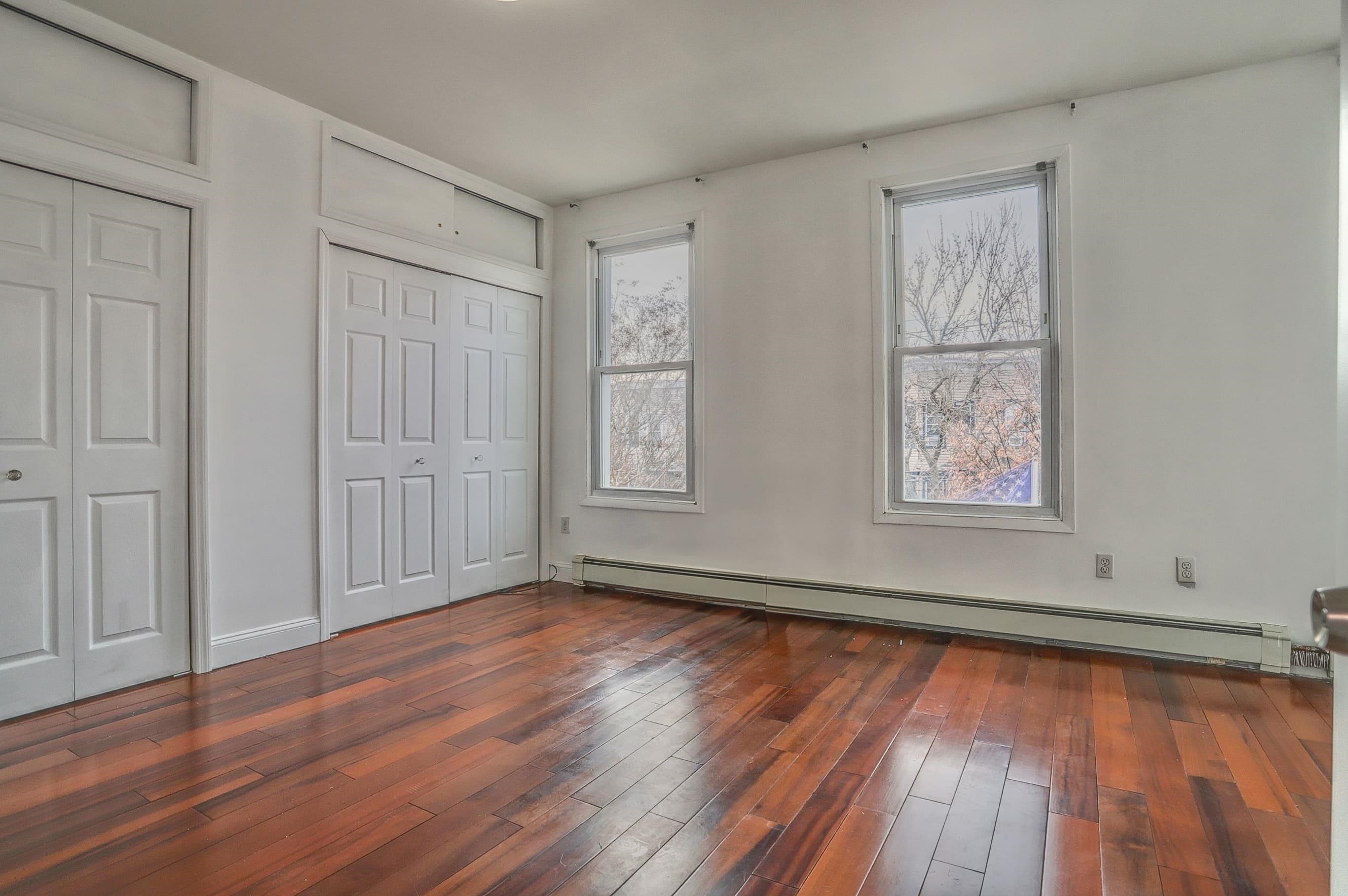 206 Dodd Street, Unit 2 Weehawken, NJ 07086 - Photo 12 of 20 a view of an empty room with wooden floor and a window