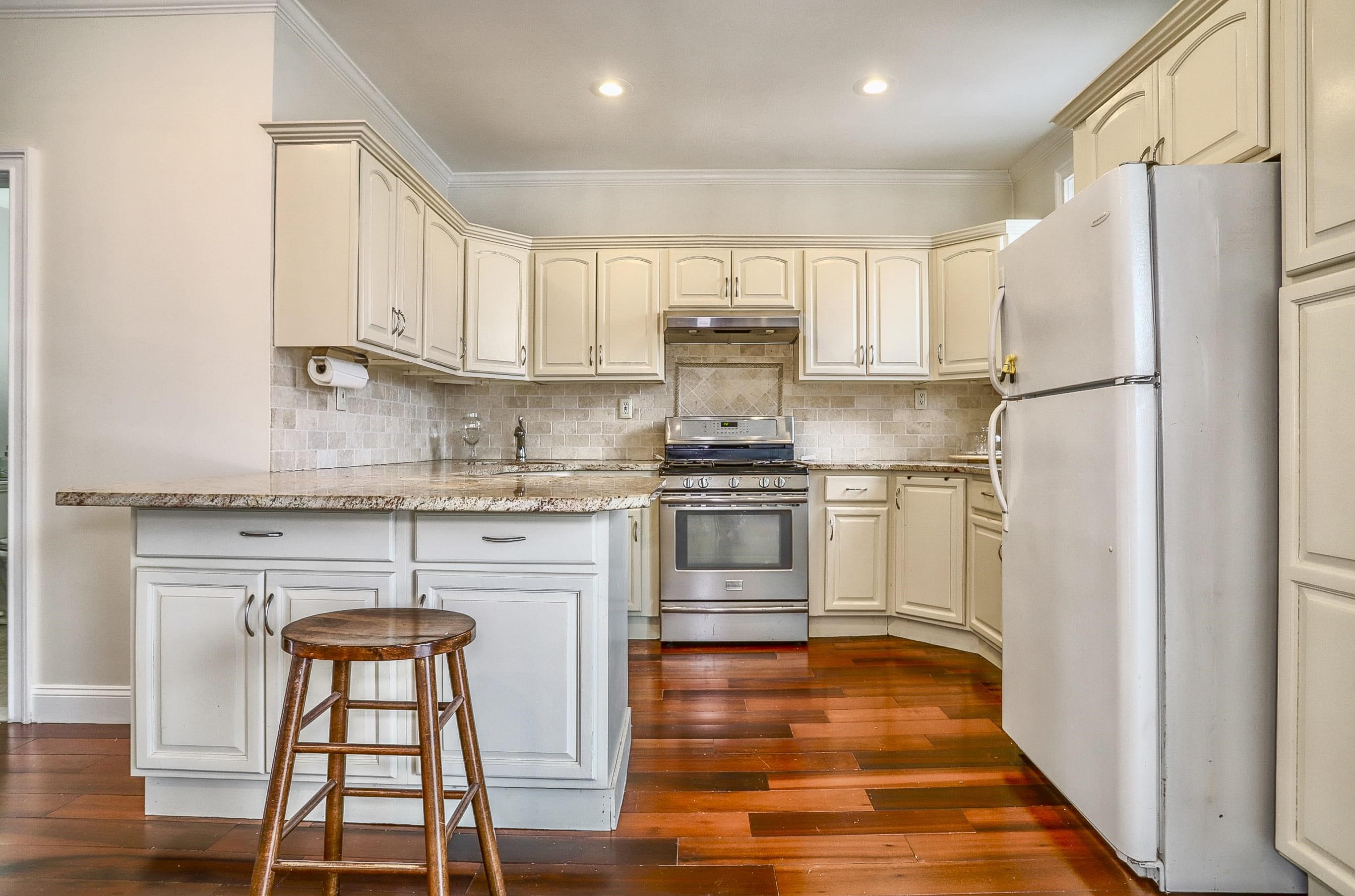 206 Dodd Street, Unit 2 Weehawken, NJ 07086 - Photo 4 of 20 a kitchen with stainless steel appliances granite countertop a refrigerator sink and cabinets