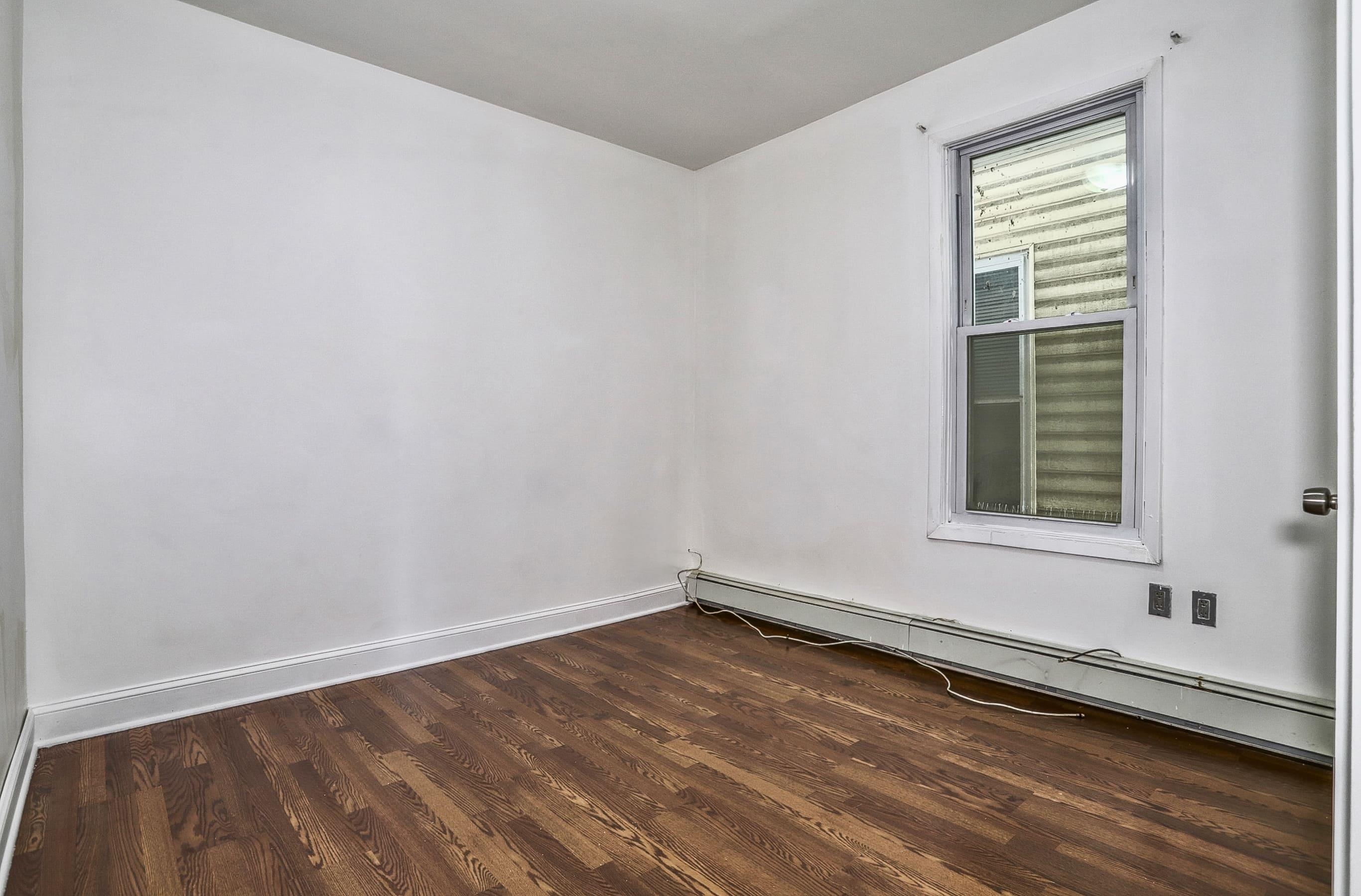 206 Dodd Street, Unit 2 Weehawken, NJ 07086 - Photo 10 of 20 a view of an empty room with wooden floor and a window