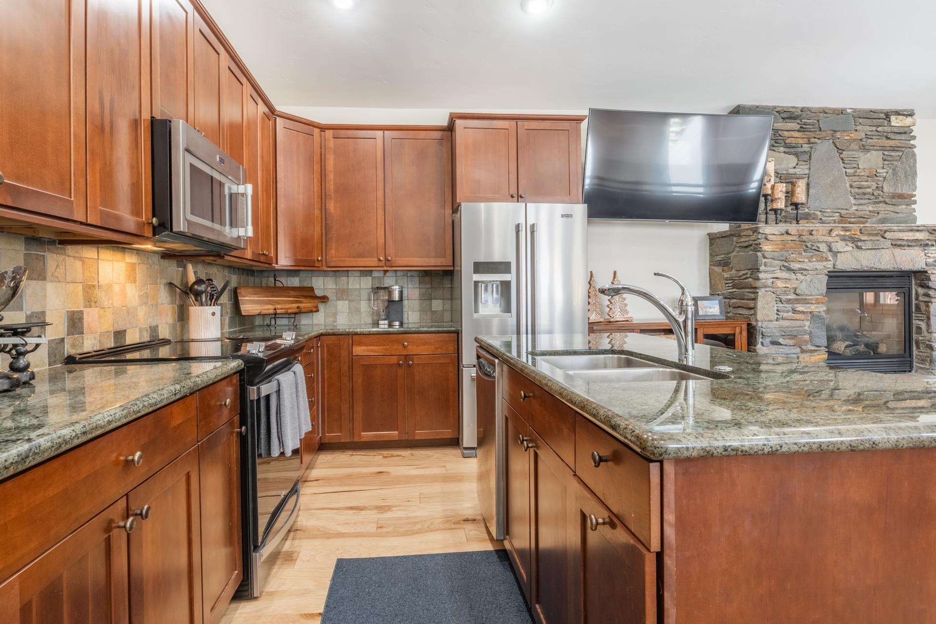 125 Davison Road, Unit 1 Mammoth Lakes, CA 93546 - Photo 7 of 46 a kitchen with stainless steel appliances granite countertop a sink stove and refrigerator