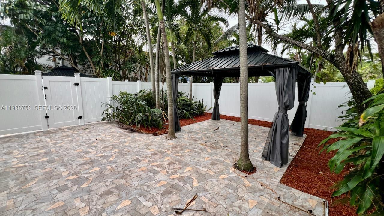 48 Southwest 14th Street Dania Beach, FL 33004 - Photo 13 of 13 a backyard of a house with table and chairs