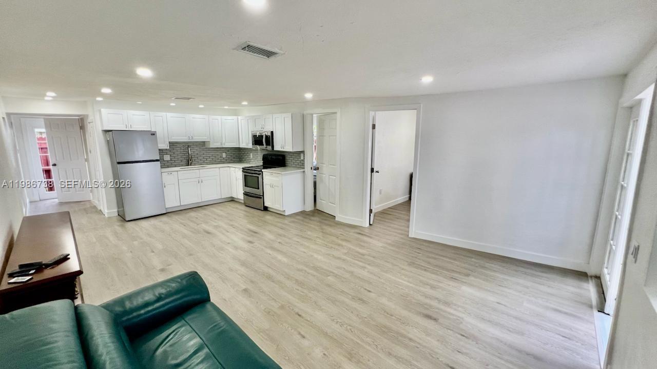 48 Southwest 14th Street Dania Beach, FL 33004 - Photo 4 of 13 a living room with furniture and kitchen view
