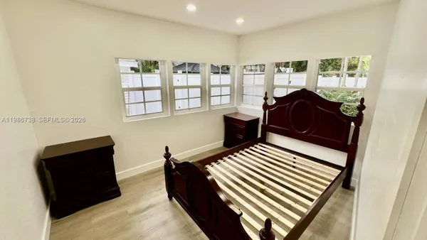 a bedroom with furniture and a window