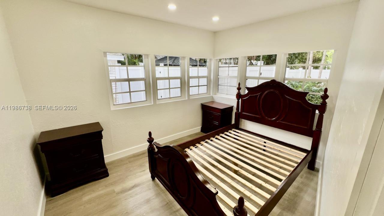 48 Southwest 14th Street Dania Beach, FL 33004 - Photo 6 of 13 a bedroom with furniture and a window